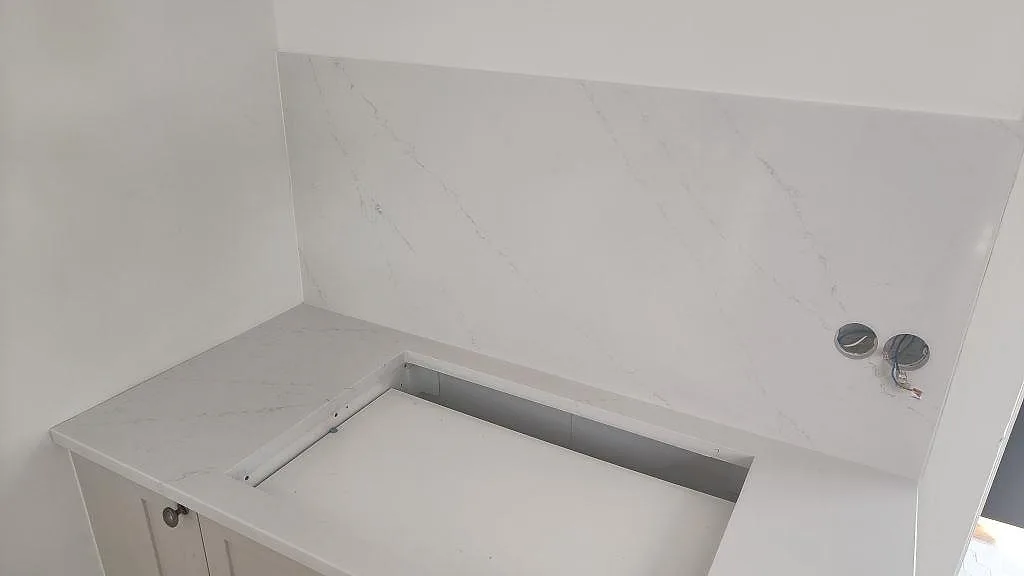 Detalj af hällöppning i hvid Silestone Eternal Statuario, poleret, med marmorliknande åretegning i køkken i Limhamn.